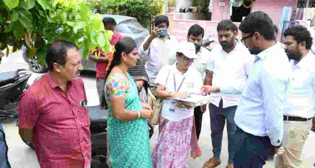 Wanaparthy District Collector Adarsh Surabhi interacts with residents during the door-to-door voter enumeration exercise launched across Telangana as part of the Special Intensive Revision process. Wanaparthy District Collector Adarsh Surabhi interacts with residents during the door-to-door voter enumeration exercise launched across Telangana as part of the Special Intensive Revision process.