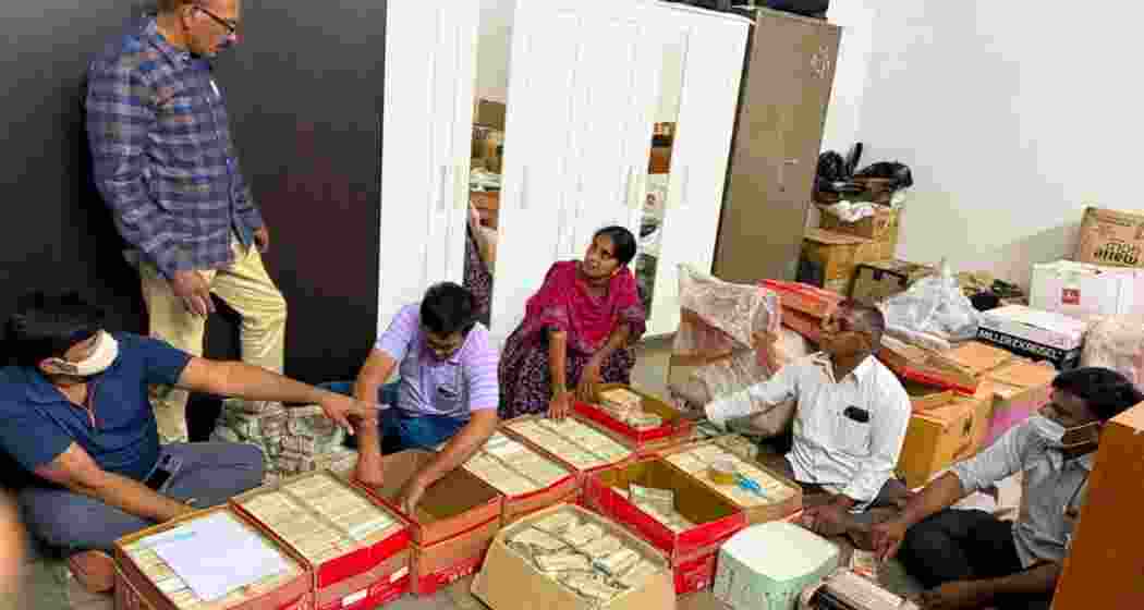 Officials tally bundles of cash seized in a raid at a Shamshabad farmhouse near Hyderabad. Officials tally bundles of cash seized in a raid at a Shamshabad farmhouse near Hyderabad.