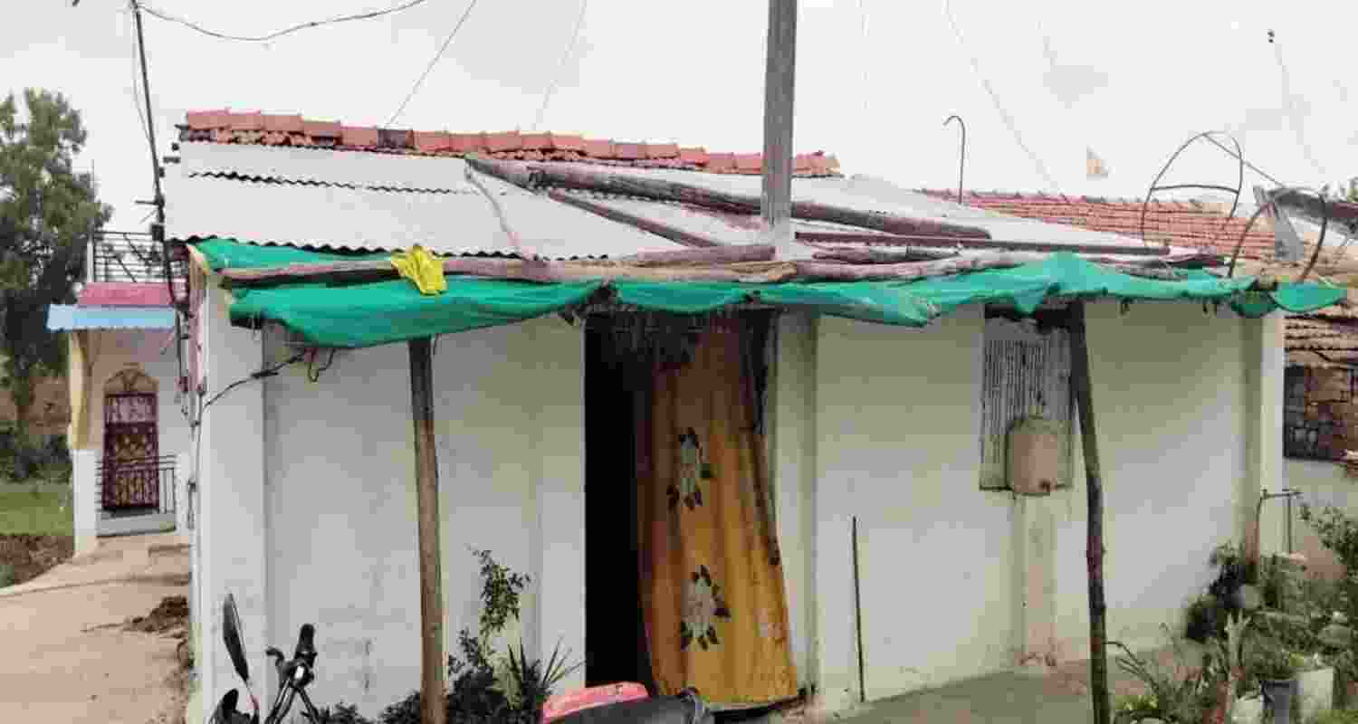 The house of Raju Kusnekar in Palakhed village, where an electric pole has stood inside the structure since 1998. The house of Raju Kusnekar in Palakhed village, where an electric pole has stood inside the structure since 1998.