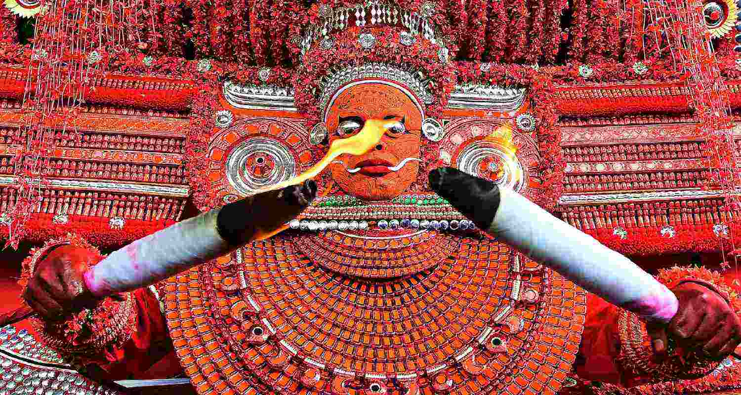 A Kerala Theyyam performer raises the thirumudi, the royal crown of the Muchilot Bhagavathi goddess during the festival in Kannur, Kerala A Kerala Theyyam performer raises the thirumudi, the royal crown of the Muchilot Bhagavathi goddess during the festival in Kannur, Kerala