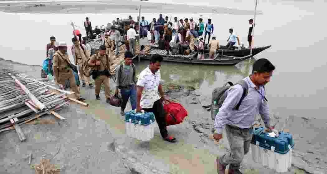 Polling officials carry election materials after disembarking from a boat as they head to a remote polling station ahead of the first phase of India's general election in the Majuli district, in the northeastern state of Assam, India. Polling officials carry election materials after disembarking from a boat as they head to a remote polling station ahead of the first phase of India's general election in the Majuli district, in the northeastern state of Assam, India.