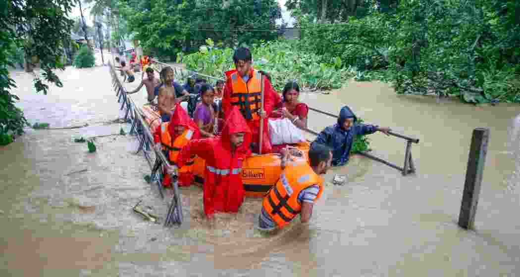A man carrying his pet dog shifts to a safer place from a flood-affected area following heavy monsoon rainfall, at Adhaynagar village, on the outskirts of Agartala, Thursday, Aug. 22, 2024. A man carrying his pet dog shifts to a safer place from a flood-affected area following heavy monsoon rainfall, at Adhaynagar village, on the outskirts of Agartala, Thursday, Aug. 22, 2024.