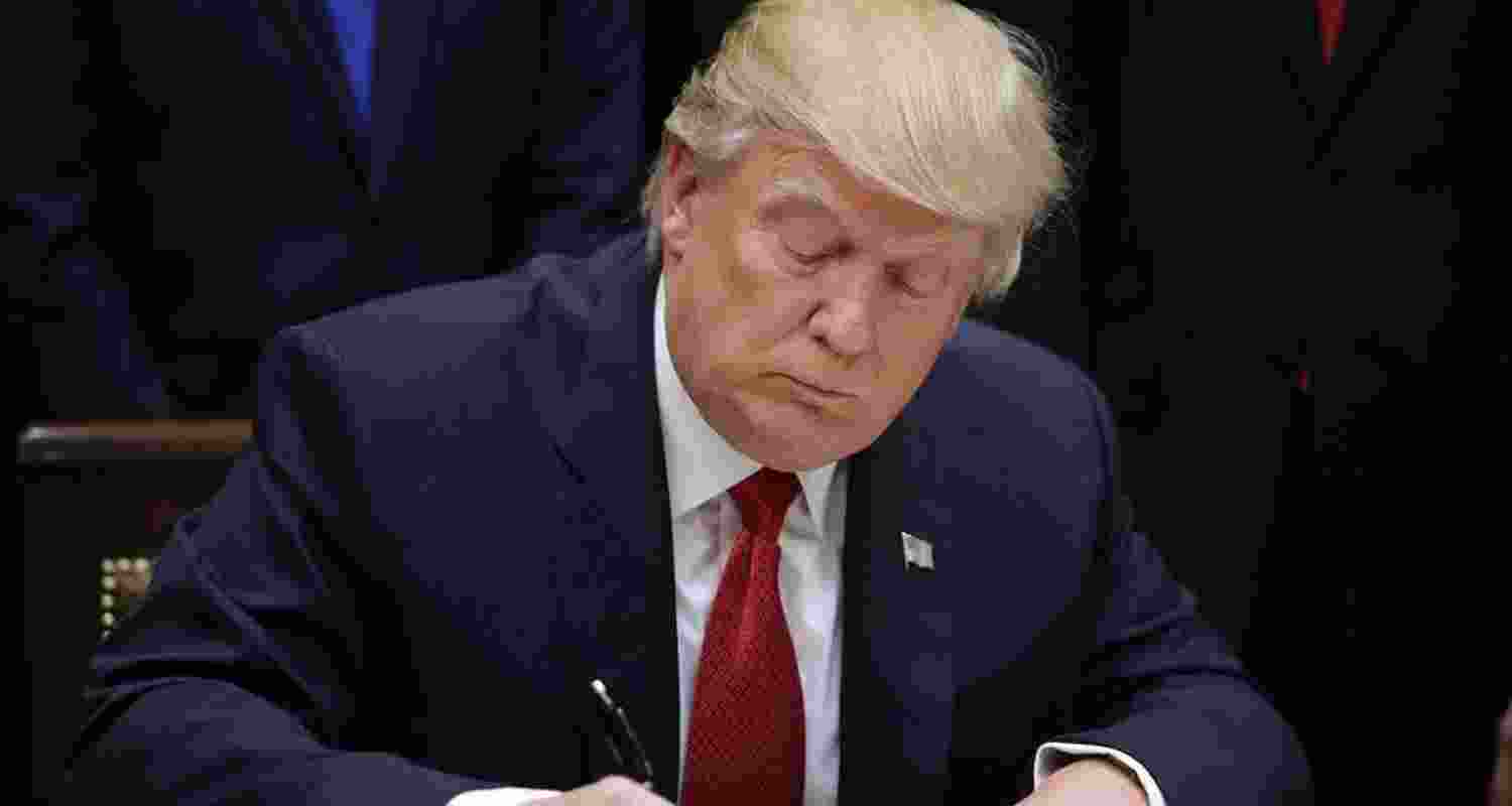 US President Trump signs an executive order. File Photo. US President Trump signs an executive order. File Photo.