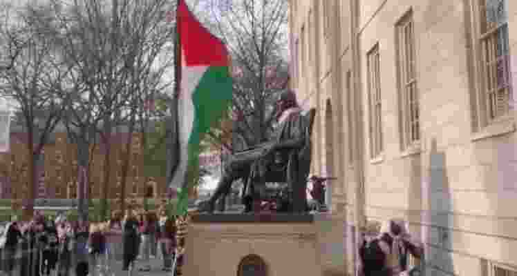 As tensions over the Gaza War grip universities nationwide, Harvard University witnessed a symbolic act of protest as anti-Israel demonstrators raised the Palestinian flag over the John Harvard statue in Harvard Yard. As tensions over the Gaza War grip universities nationwide, Harvard University witnessed a symbolic act of protest as anti-Israel demonstrators raised the Palestinian flag over the John Harvard statue in Harvard Yard.