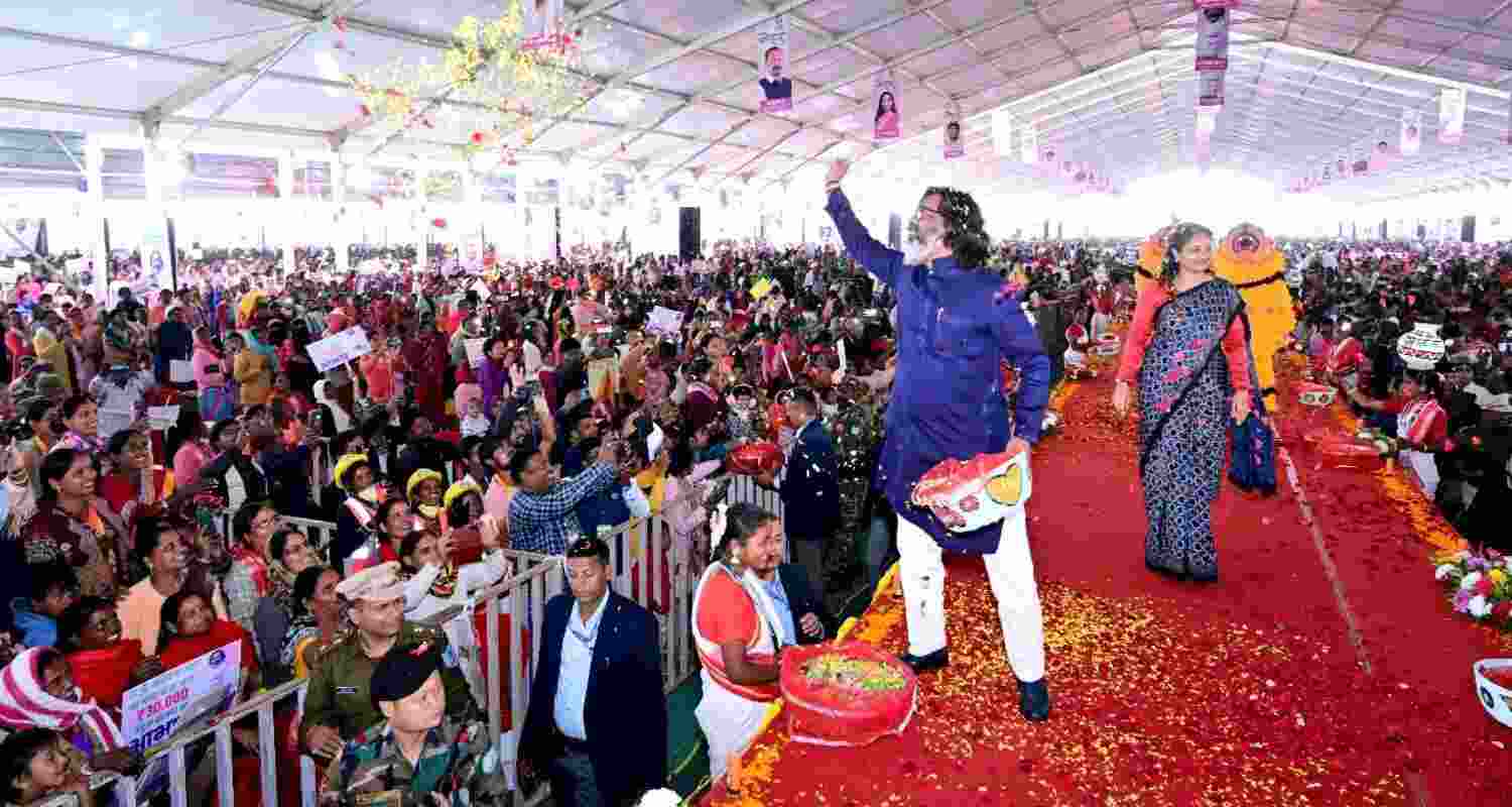 Jharkhand Chief Minister Hemant Soren along with his wife and MLA Kalpana Murmu Soren showers flowers on the beneficiary women during a programme of honorarium distribution of JMMSY in Ranchi on Monday. Jharkhand Chief Minister Hemant Soren along with his wife and MLA Kalpana Murmu Soren showers flowers on the beneficiary women during a programme of honorarium distribution of JMMSY in Ranchi on Monday.
