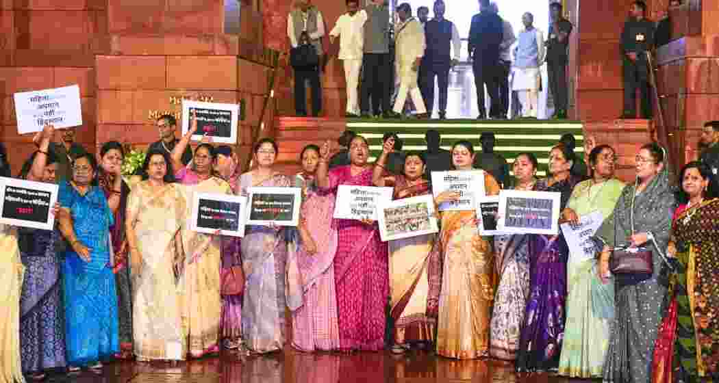 NDA MPs raise slogans during a protest amid rain, after the Constitution Amendment Bill to implement reservation for women in legislatures in 2029 and increase the number of seats of the Lok Sabha was defeated, during the Special session of Parliament, in New Delhi, on Friday. NDA MPs raise slogans during a protest amid rain, after the Constitution Amendment Bill to implement reservation for women in legislatures in 2029 and increase the number of seats of the Lok Sabha was defeated, during the Special session of Parliament, in New Delhi, on Friday.