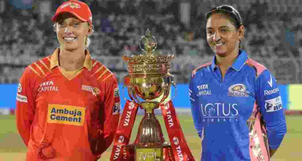 Ashleigh Gardner of Gujarat Giants and Harmanpreet Kaur of Mumbai Indians share a moment with the WPL trophy. Ashleigh Gardner of Gujarat Giants and Harmanpreet Kaur of Mumbai Indians share a moment with the WPL trophy.