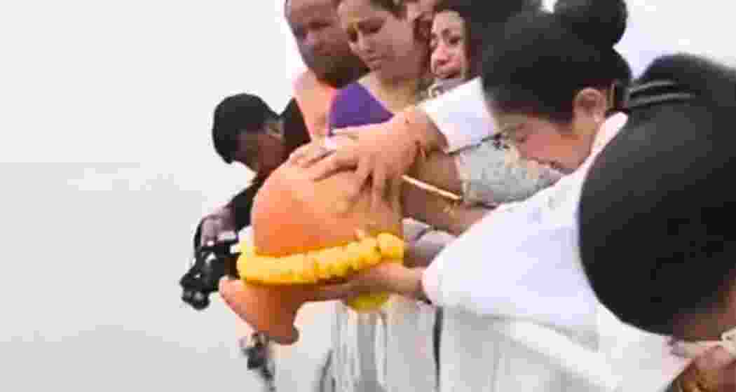 Garima Garg immerses the ashes of her late husband, Zubeen Garg, in the Brahmaputra River. Garima Garg immerses the ashes of her late husband, Zubeen Garg, in the Brahmaputra River.