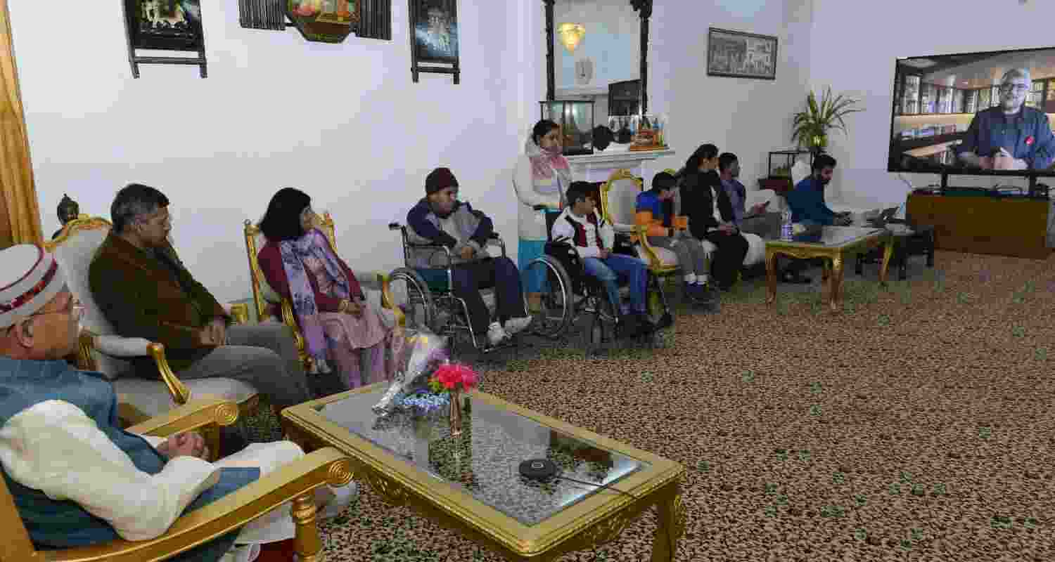"Video conference featuring the Governor of Himachal Pradesh and representatives from the Muscular Dystrophy community engaging in discussions with film director Vivek Agnihotri."  "Video conference featuring the Governor of Himachal Pradesh and representatives from the Muscular Dystrophy community engaging in discussions with film director Vivek Agnihotri."