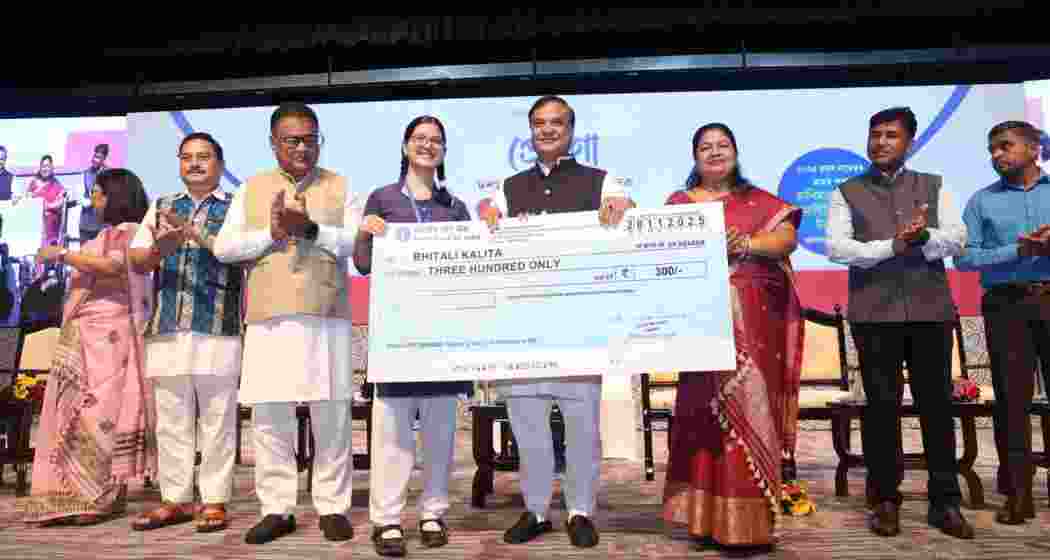 Assam Chief Minister Himanta Biswa Sarma presents a cheque to a schoolgirl during the launch of the Prerona scheme in Guwahati on Friday. Assam Chief Minister Himanta Biswa Sarma presents a cheque to a schoolgirl during the launch of the Prerona scheme in Guwahati on Friday.