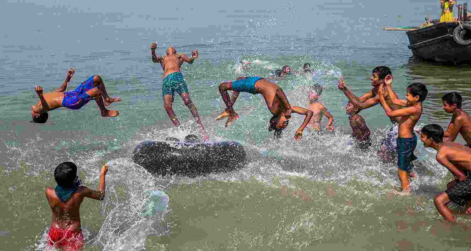 Boys in Nadia showcased their agility with somersaults by the Hooghly River on a Friday morning Boys in Nadia showcased their agility with somersaults by the Hooghly River on a Friday morning
