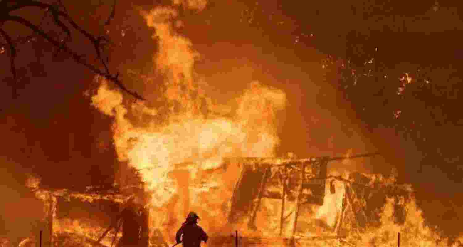 A man stands next to a huge flame in Santiago, Chile where wildfires have led to 123 dead and hundreds missing A man stands next to a huge flame in Santiago, Chile where wildfires have led to 123 dead and hundreds missing