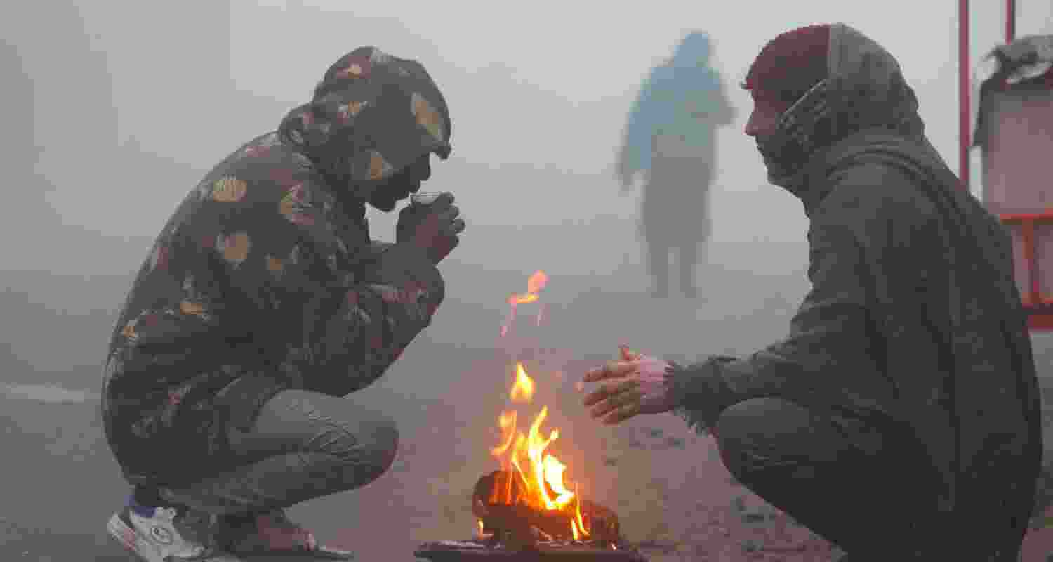 People warm themselves around a bonfire on a foggy winter morning, in Jammu, Tuesday.  People warm themselves around a bonfire on a foggy winter morning, in Jammu, Tuesday.