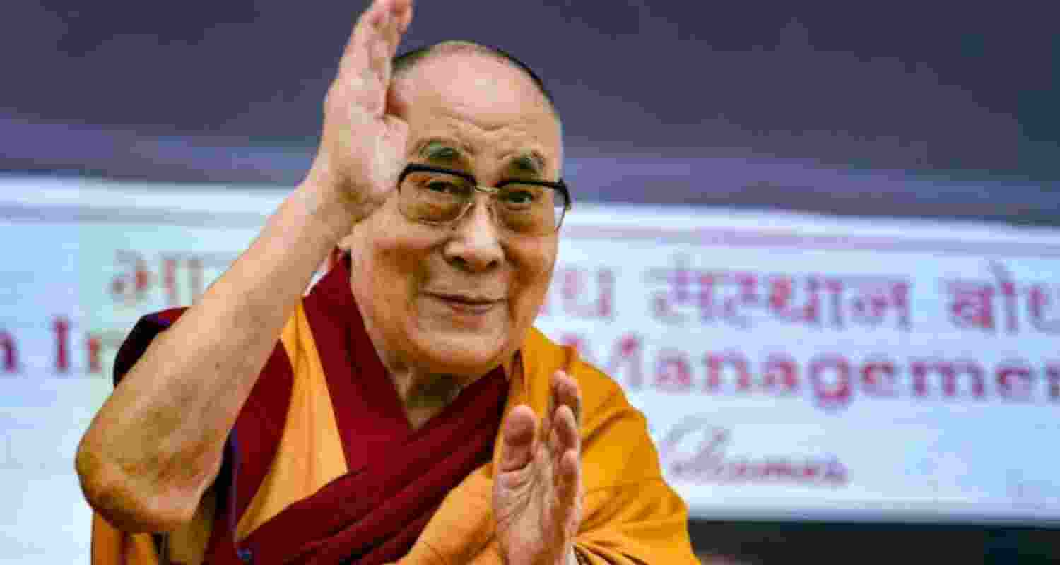 Tibetan Spiritual leader the Dalai Lama waving to spectators at an event. Tibetan Spiritual leader the Dalai Lama waving to spectators at an event.