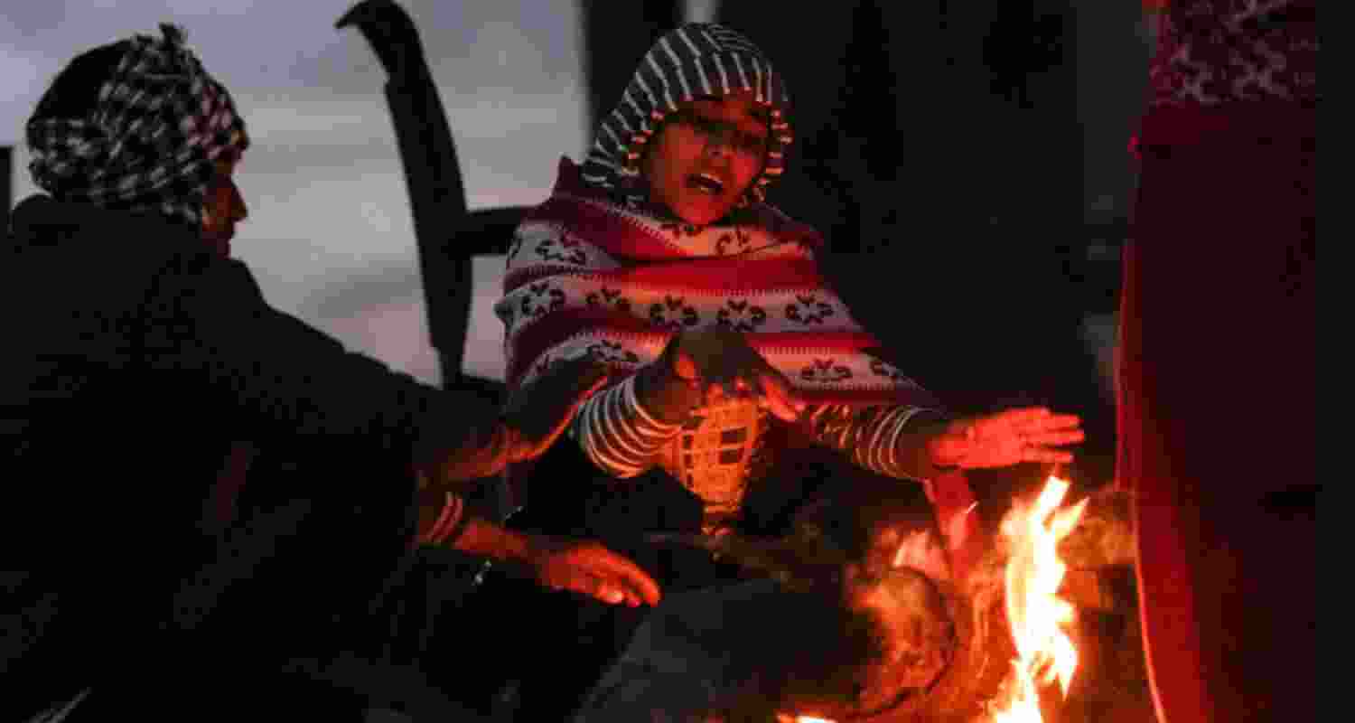 People warm themselves around a bonfire on a foggy winter morning, in New Delhi, Saturday.  People warm themselves around a bonfire on a foggy winter morning, in New Delhi, Saturday.