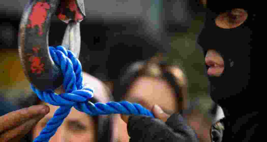 A prison official prepares the execution rope before a scheduled hanging in Iran.  A prison official prepares the execution rope before a scheduled hanging in Iran.