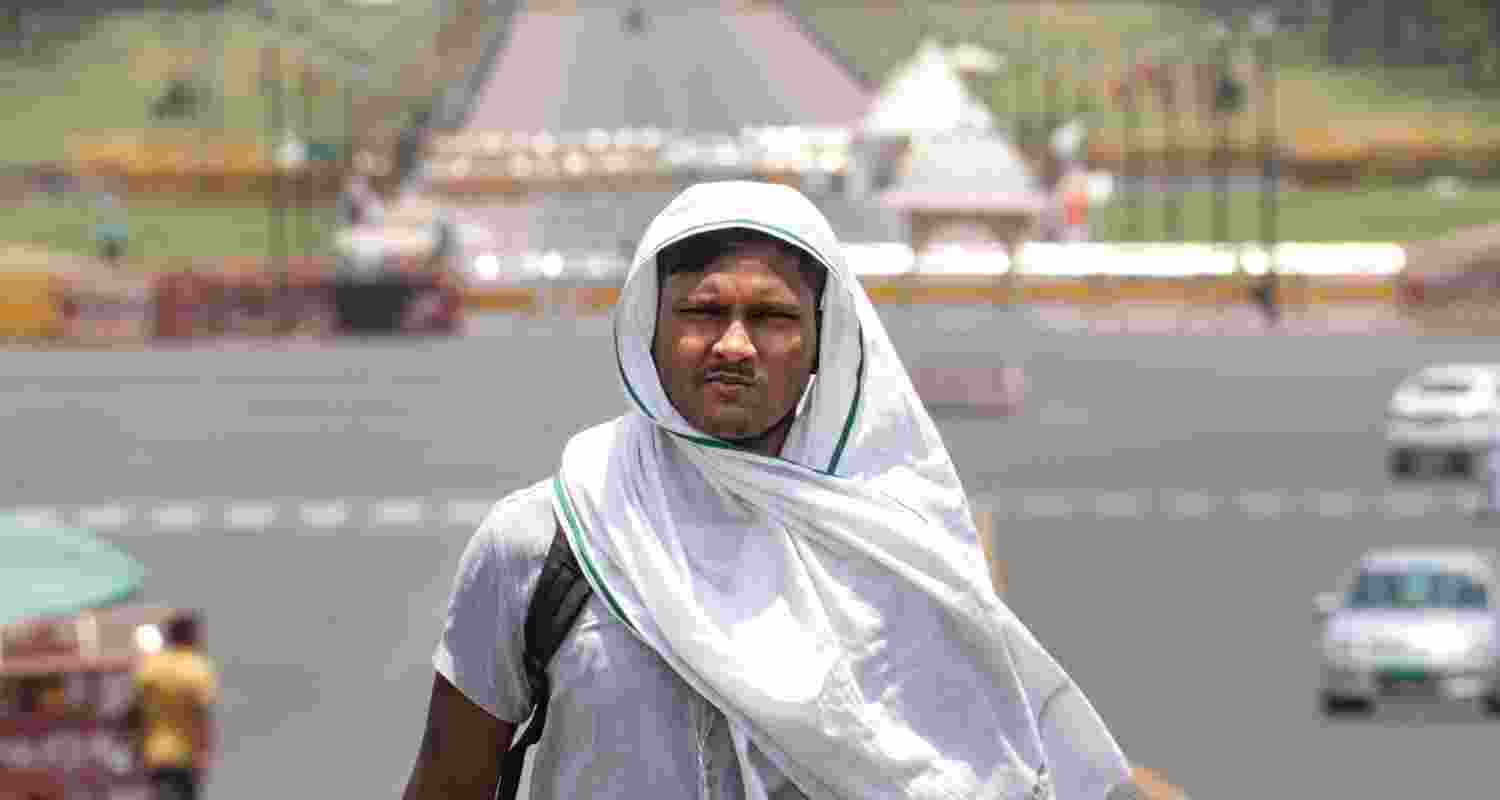 A man covers his head for protection from the scorching sun on a hot summer day, in New Delhi, Tuesday, June 18, 2024. The India Meteorological Department (IMD) has issued a 'red' alert because of prevailing heatwave conditions in the national capital. A man covers his head for protection from the scorching sun on a hot summer day, in New Delhi, Tuesday, June 18, 2024. The India Meteorological Department (IMD) has issued a 'red' alert because of prevailing heatwave conditions in the national capital.