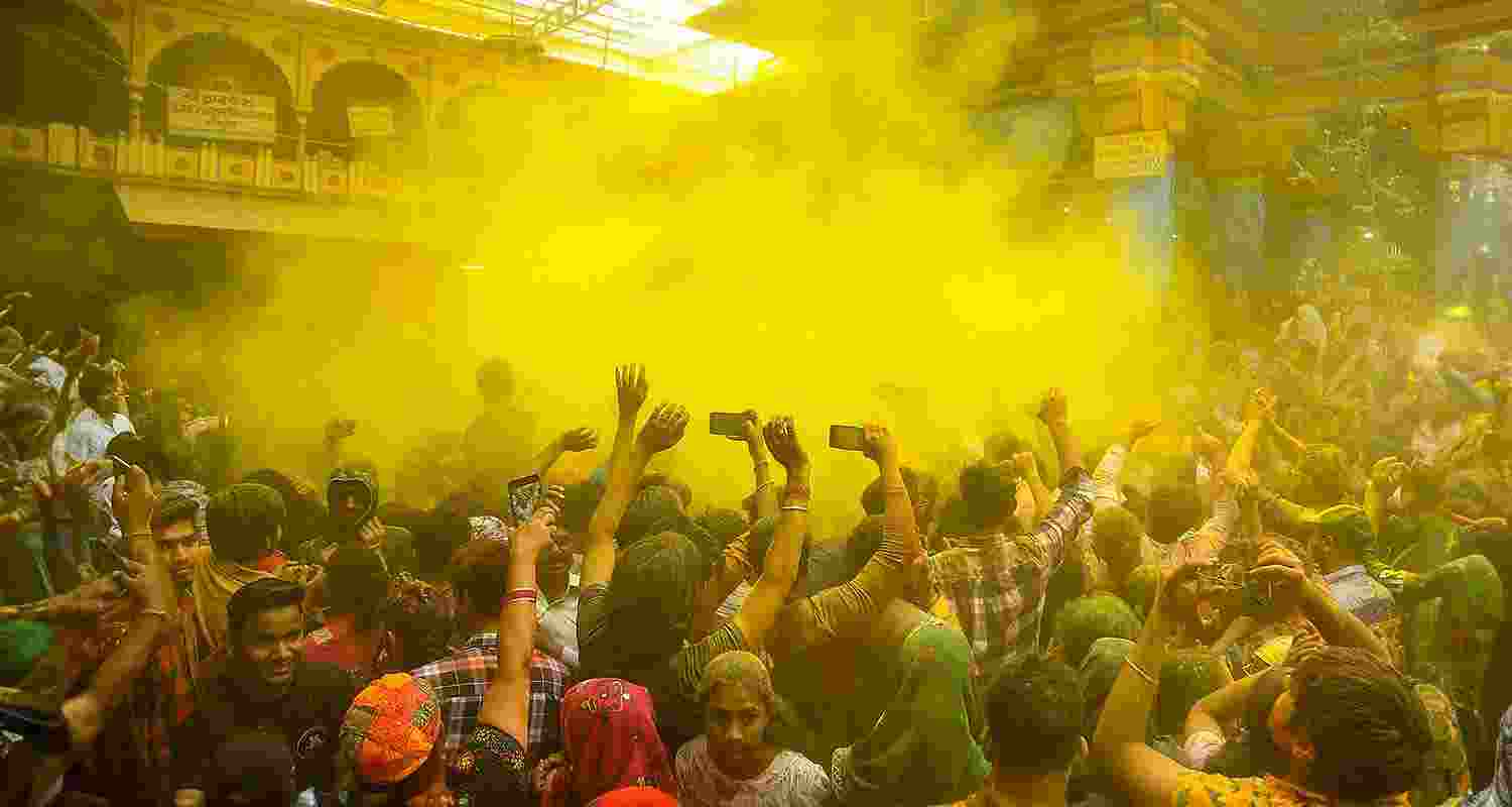 Devotees celebrate with colours during Holi celebration at the Dwarkadhish Temple, in Mathura Devotees celebrate with colours during Holi celebration at the Dwarkadhish Temple, in Mathura