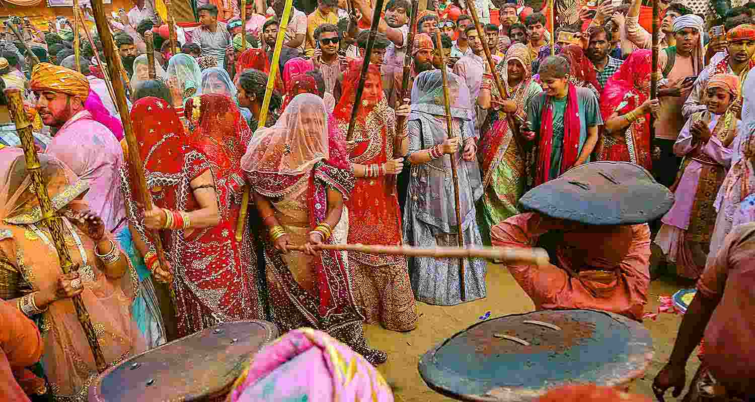 Devotees during Latthamaar Holi celebration at Sri Ji temple at Barsana near Mathura Devotees during Latthamaar Holi celebration at Sri Ji temple at Barsana near Mathura