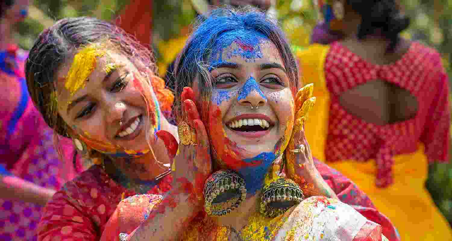 Women play with colours ahead of the festival of Holi, in Nadia Women play with colours ahead of the festival of Holi, in Nadia