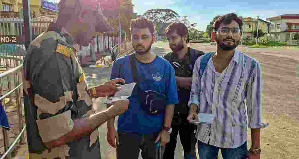 Students gather at the Indian border, their passports being scrutinised by a BSF personnel, following the outbreak of violence in Bangladesh. Students gather at the Indian border, their passports being scrutinised by a BSF personnel, following the outbreak of violence in Bangladesh.