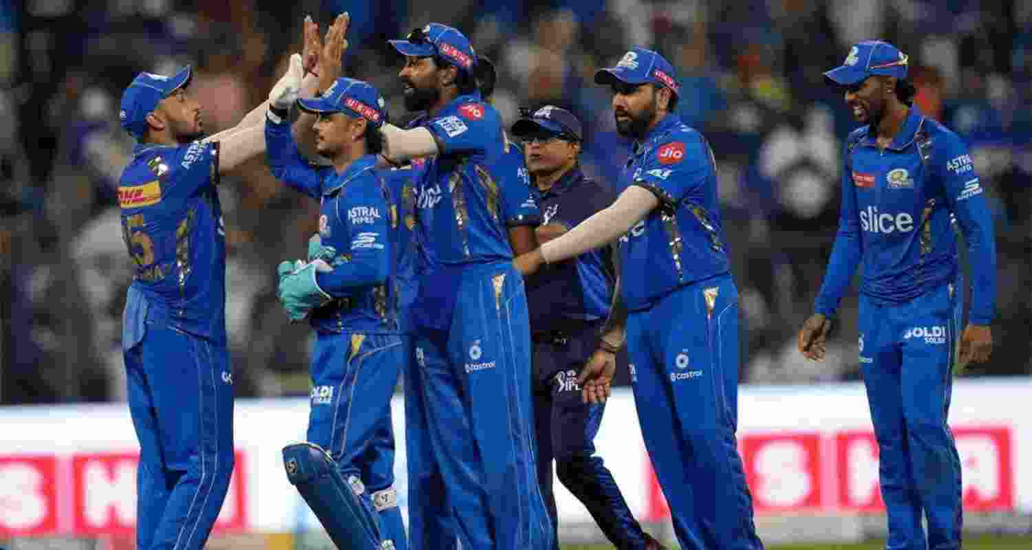 Mumbai Indians celebrating the fall of a wicket. Mumbai Indians celebrating the fall of a wicket.