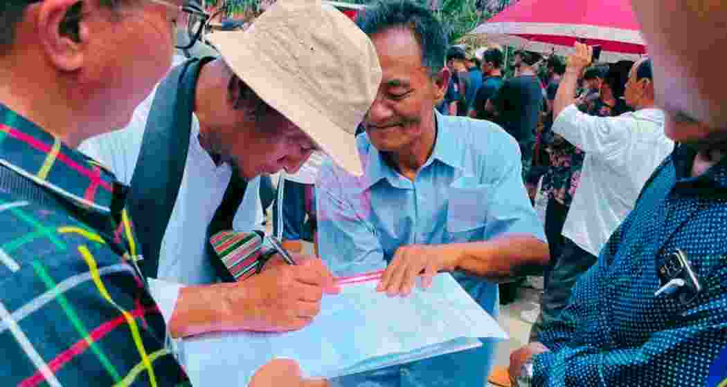 ITLF chairman Pagin Haokip signing a similar memorandum to be sent to Home Minister Amit Shah before submitting it to DC in June. File photo. ITLF chairman Pagin Haokip signing a similar memorandum to be sent to Home Minister Amit Shah before submitting it to DC in June. File photo.