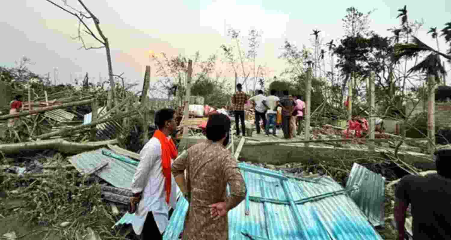 Houses are damaged and electric poles fell after a heavy storm that left at least five people dead, in Jalpaiguri, West Bengal, on March 31.  Houses are damaged and electric poles fell after a heavy storm that left at least five people dead, in Jalpaiguri, West Bengal, on March 31.