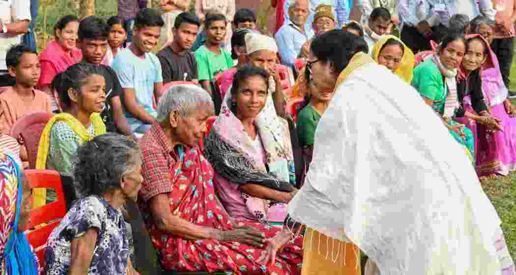 West Bengal Chief Minister Mamata Banerjee interacts with elderly people at an old age home during her visit after a recent storm that left at least five people dead and rendered over 200 homeless, in Jalpaiguri district on Tuesday.  West Bengal Chief Minister Mamata Banerjee interacts with elderly people at an old age home during her visit after a recent storm that left at least five people dead and rendered over 200 homeless, in Jalpaiguri district on Tuesday.