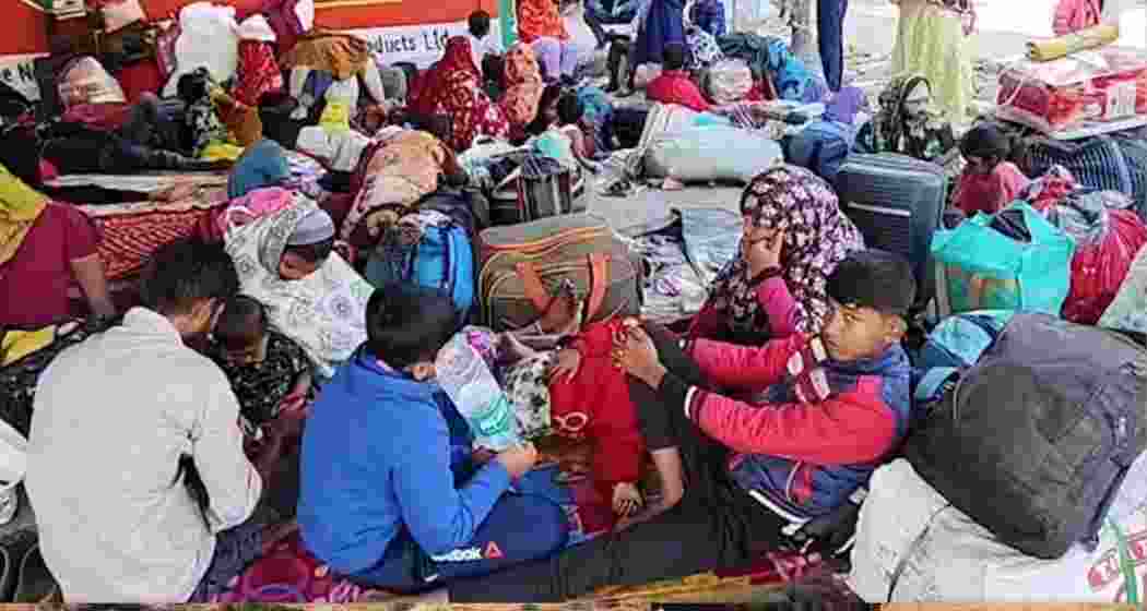 Undocumented Bangladeshi nationals wait with their belongings at the Hakimpur border check-post in North 24 Parganas. Undocumented Bangladeshi nationals wait with their belongings at the Hakimpur border check-post in North 24 Parganas.