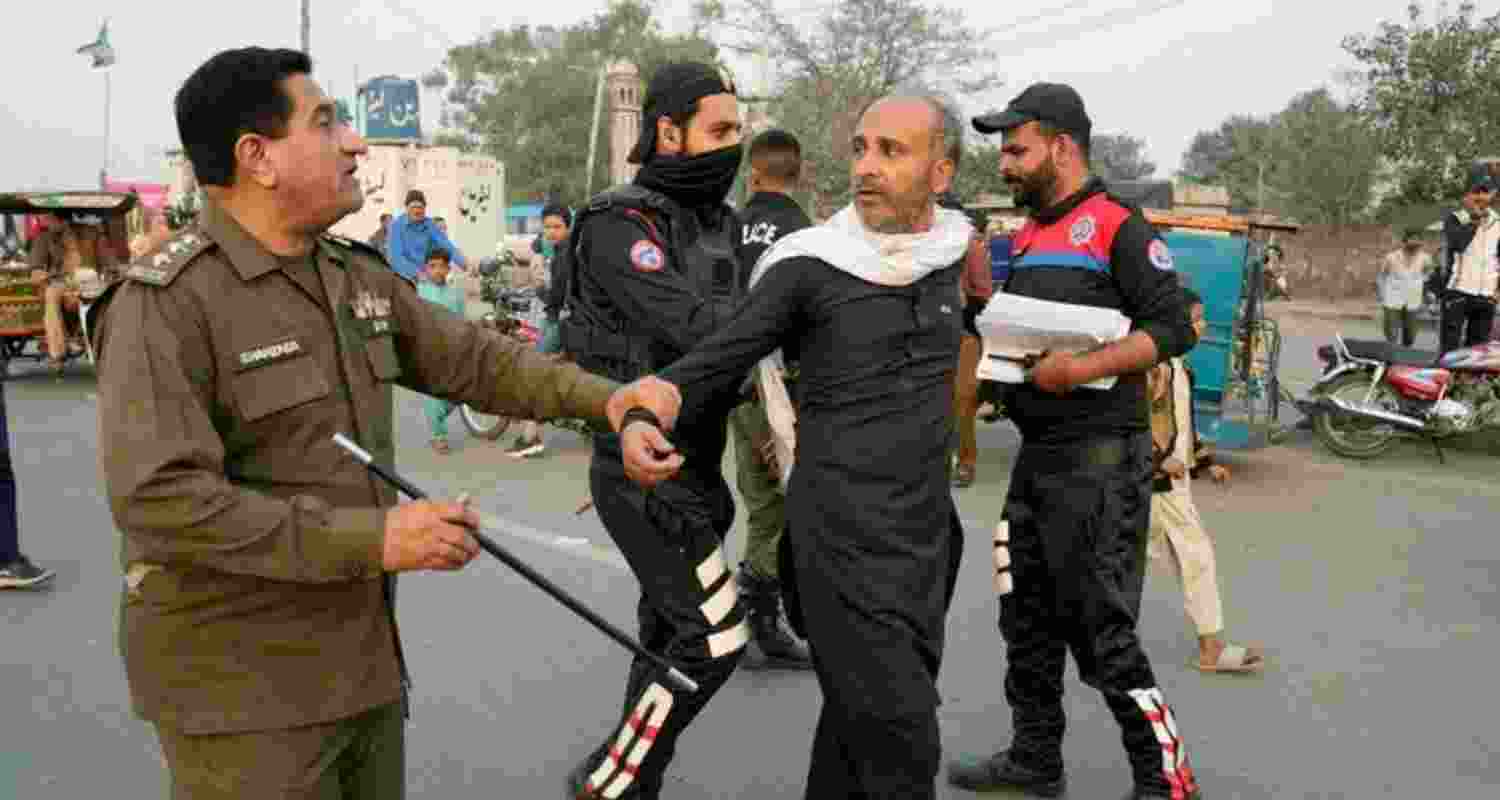 A police officer detains a supporter of former Prime Minister Imran Khan. Image: X A police officer detains a supporter of former Prime Minister Imran Khan. Image: X