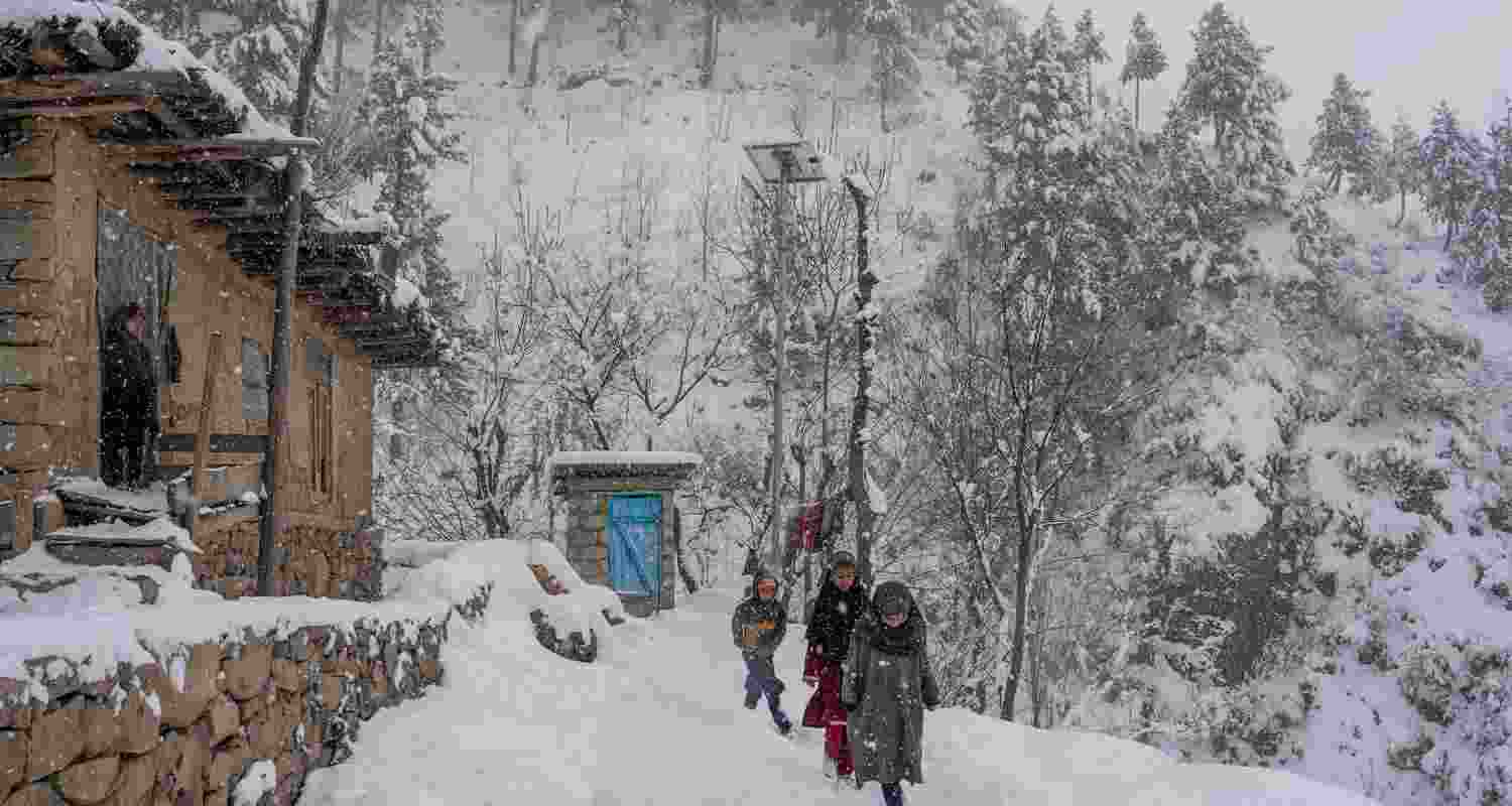 Children walking in the snow on the outskirts of Srinagar Children walking in the snow on the outskirts of Srinagar