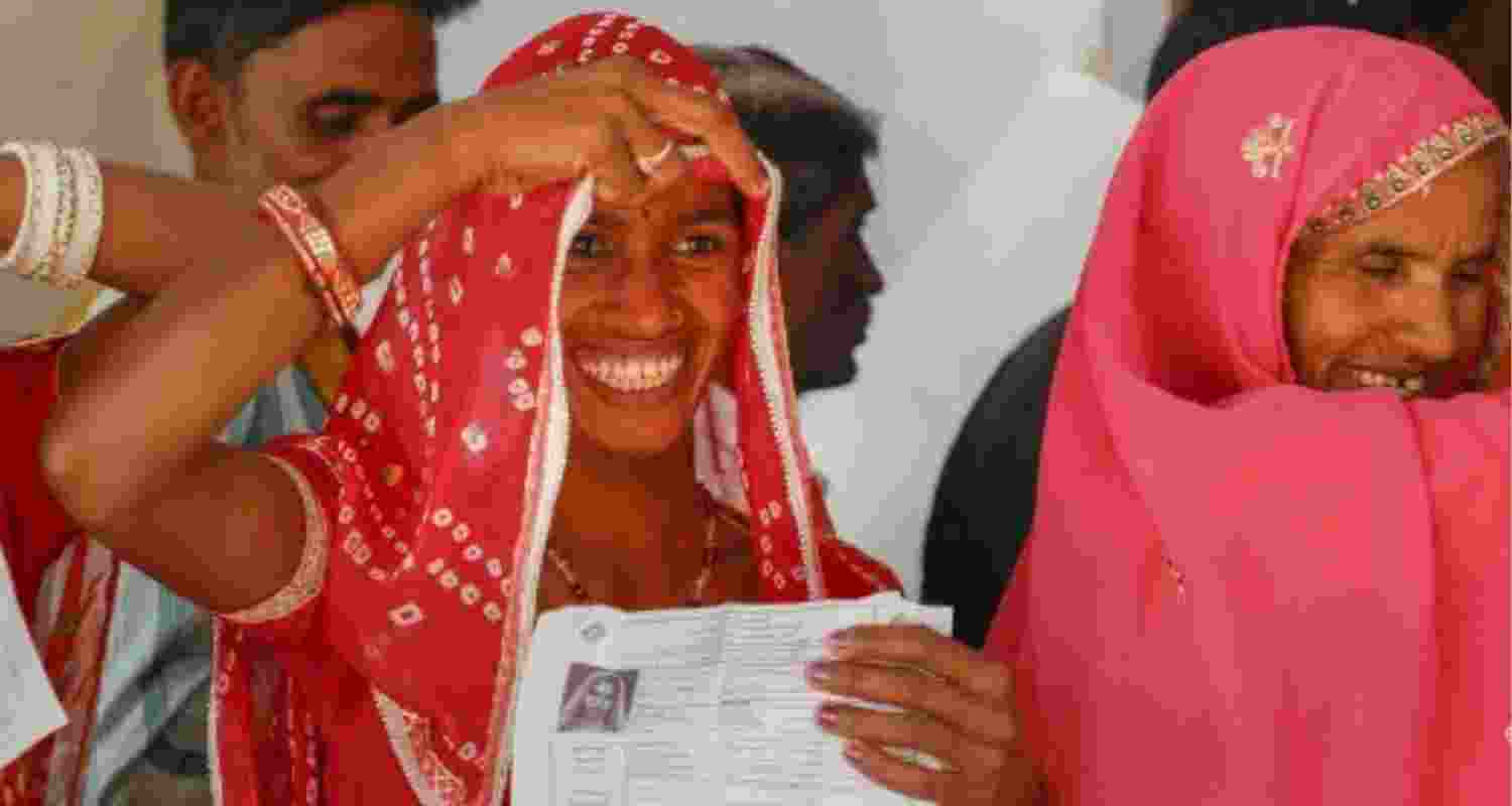 Voter smiles while casting vote. Voter smiles while casting vote.