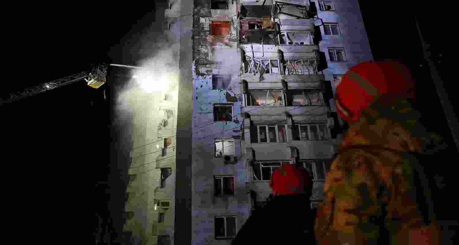 Rescue workers try to put out a fire of a residential building burning after a Russian drone attack on Zaporizhzhia, Ukraine, Tuesday. Rescue workers try to put out a fire of a residential building burning after a Russian drone attack on Zaporizhzhia, Ukraine, Tuesday.