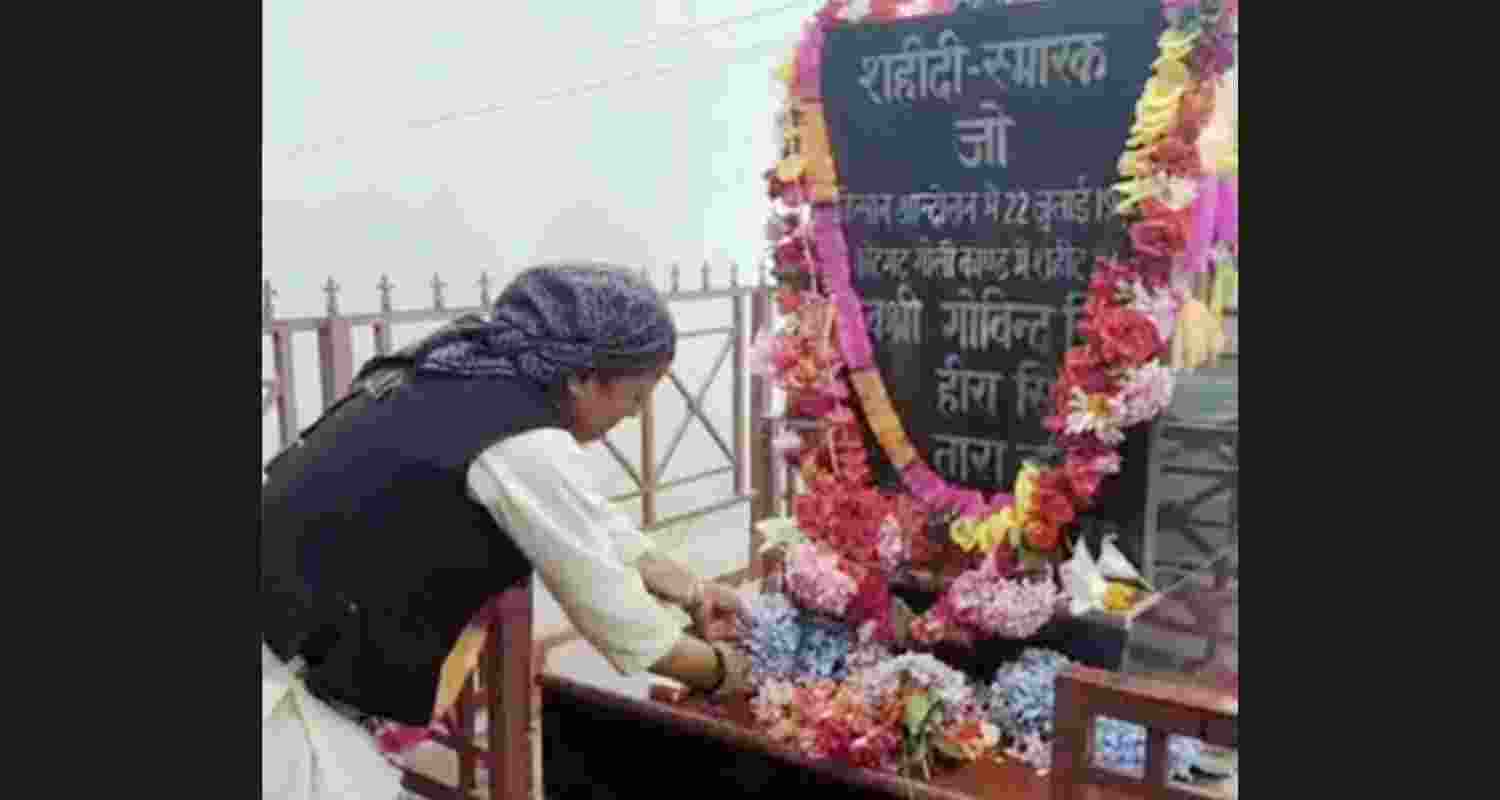 A woman pays tribute to three apple farmers who lost their lives in police firing at Kotgarh in 1990. A woman pays tribute to three apple farmers who lost their lives in police firing at Kotgarh in 1990.