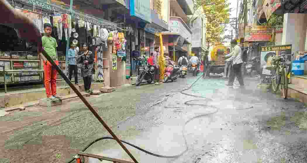 Municipal workers clear roads during sanitation drives following the typhoid outbreak in Gandhinagar. Municipal workers clear roads during sanitation drives following the typhoid outbreak in Gandhinagar.