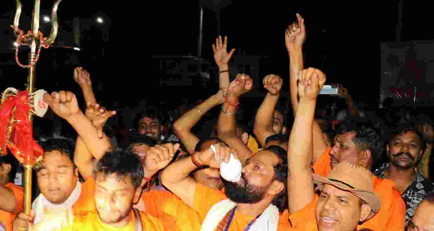 Pilgrims shout slogans as the first batch of pilgrims leaves for the Amarnath Yatra, in Jammu, Friday. Pilgrims shout slogans as the first batch of pilgrims leaves for the Amarnath Yatra, in Jammu, Friday.