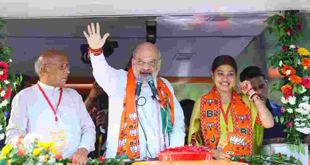 Union Home Minister Amit Shah waves to enthusiastic crowds during a grand roadshow in Jamshedpur, joined by NDA leaders Purnima Sahu and Saryu Roy, as part of BJP's comeback campaign in Jharkhand. Union Home Minister Amit Shah waves to enthusiastic crowds during a grand roadshow in Jamshedpur, joined by NDA leaders Purnima Sahu and Saryu Roy, as part of BJP's comeback campaign in Jharkhand.