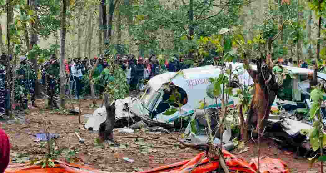 A crowd of onlookers gather at the crash site in Jharkhand's Chatra as security personnel continue search operations around the debris of the Redbird Airways Pvt Ltd Beechcraft C90 air ambulance that crashed on Monday and killed all seven members onboard. A crowd of onlookers gather at the crash site in Jharkhand's Chatra as security personnel continue search operations around the debris of the Redbird Airways Pvt Ltd Beechcraft C90 air ambulance that crashed on Monday and killed all seven members onboard.