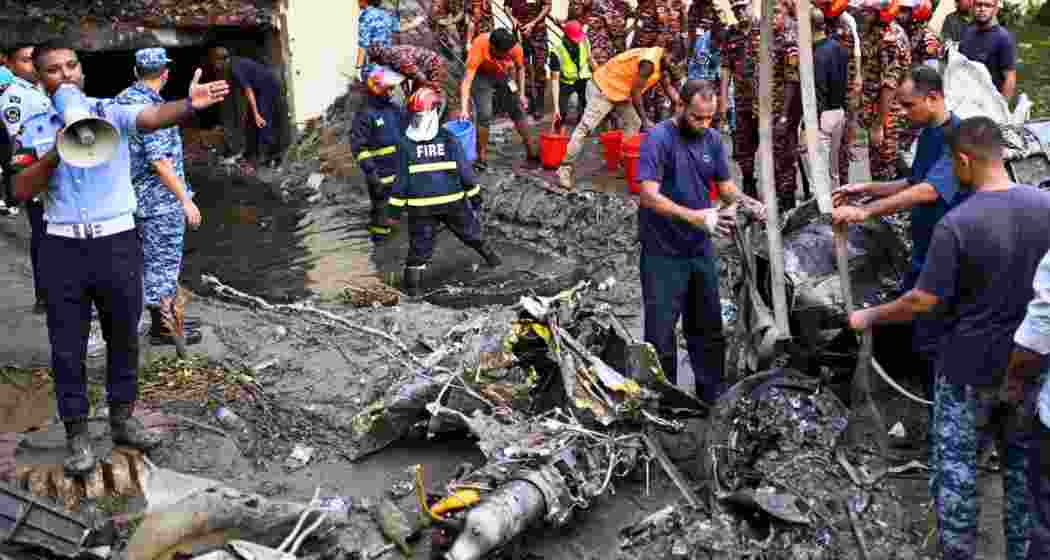 Bangladesh's fire service and security personnel conduct a search and rescue operation at the crash site. Bangladesh's fire service and security personnel conduct a search and rescue operation at the crash site.