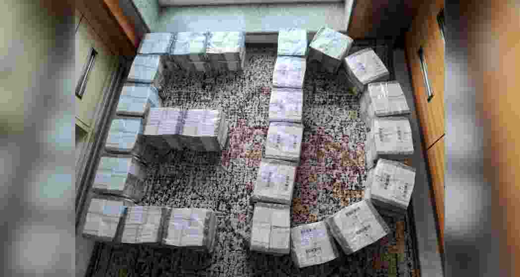 Bundles of cash seized by the Enforcement Directorate, displayed before the media. Bundles of cash seized by the Enforcement Directorate, displayed before the media.