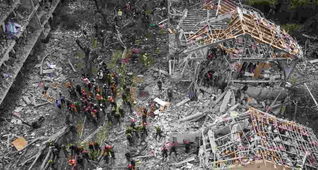Firefighters, rescue workers and military work at the site of a direct missile strike launched from Iran in Tel Aviv, Israel, on Sunday. Firefighters, rescue workers and military work at the site of a direct missile strike launched from Iran in Tel Aviv, Israel, on Sunday.