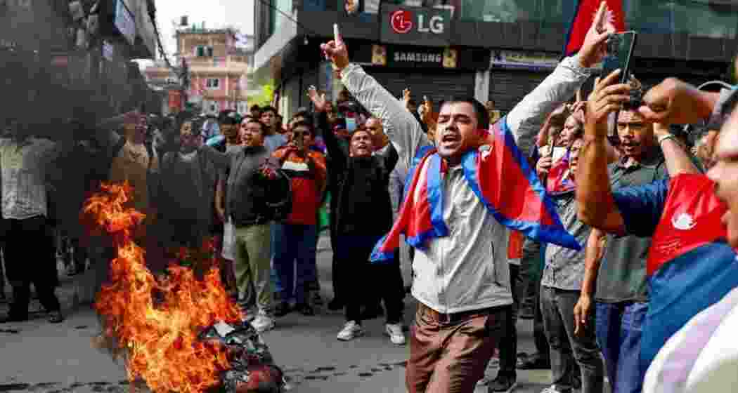 People displaying Nepal’s national flag burn tyres during a demonstration to condemn the police’s deadly crackdown on protesters in Kathmandu on September 9. People displaying Nepal’s national flag burn tyres during a demonstration to condemn the police’s deadly crackdown on protesters in Kathmandu on September 9.