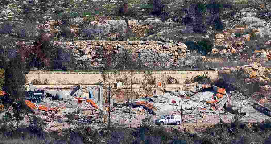 Captured from northern Israel near the Lebanon border, this image shows civilian vehicles navigating past destroyed buildings in Aita al-Shaab, southern Lebanon, on January 29, 2025. Captured from northern Israel near the Lebanon border, this image shows civilian vehicles navigating past destroyed buildings in Aita al-Shaab, southern Lebanon, on January 29, 2025.