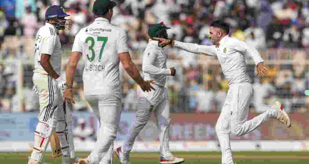 South Africa's Keshav Maharaj with teammates celebrates after the team wins during the third day of the first Test cricket match. South Africa's Keshav Maharaj with teammates celebrates after the team wins during the third day of the first Test cricket match.