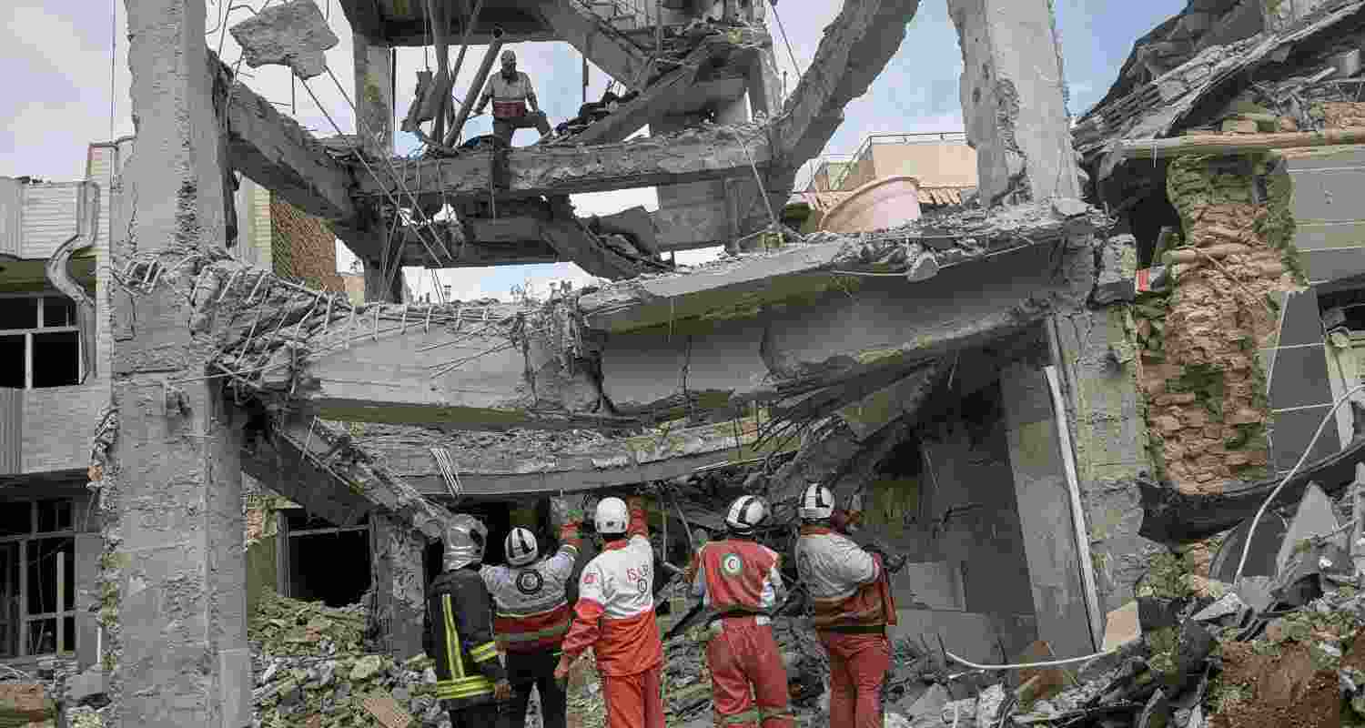 First responders inspect the remains of a residential building hit in an overnight strike during the U.S.-Israeli military campaign in Tabriz, East Azerbaijan Province, northwestern Iran, Tuesday. First responders inspect the remains of a residential building hit in an overnight strike during the U.S.-Israeli military campaign in Tabriz, East Azerbaijan Province, northwestern Iran, Tuesday.