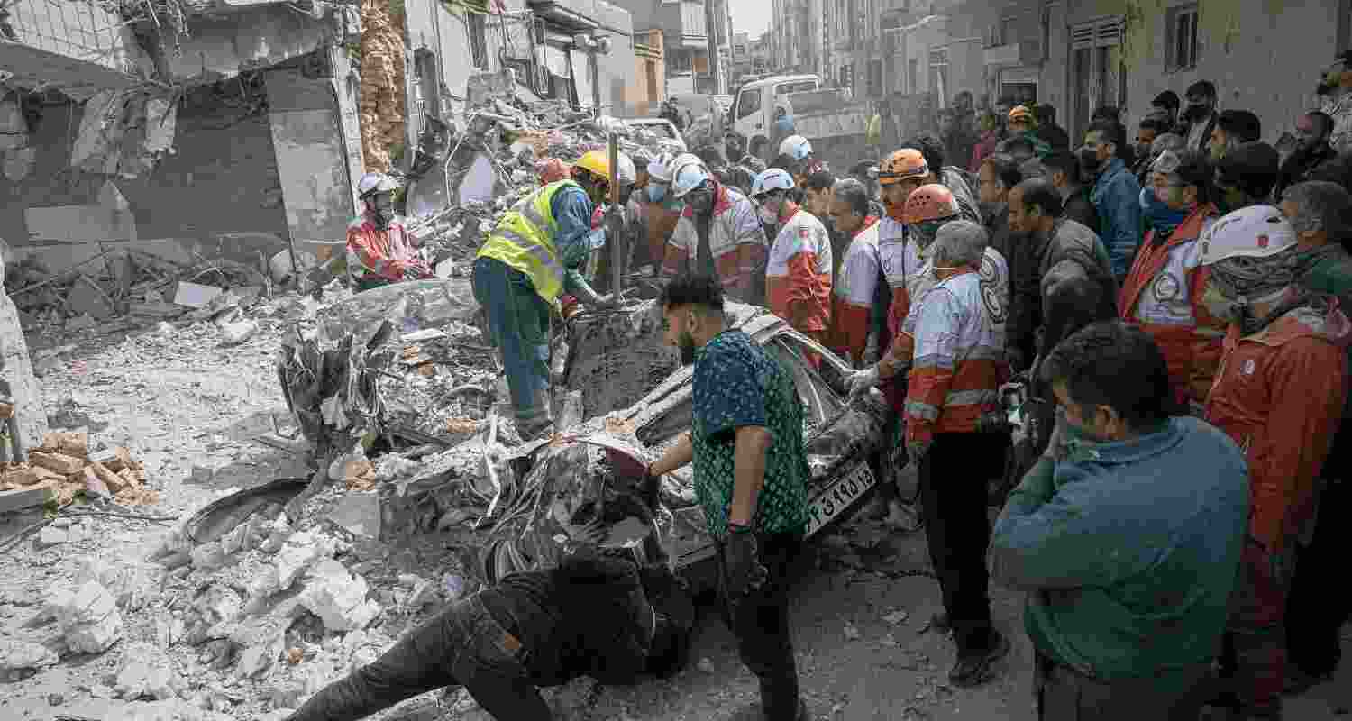 First responders inspect a destroyed car at the site of a residential building hit in an overnight strike during the U.S.-Israeli military campaign in Tabriz, East Azerbaijan Province, northwestern Iran, Tuesday, March 24, 2026. First responders inspect a destroyed car at the site of a residential building hit in an overnight strike during the U.S.-Israeli military campaign in Tabriz, East Azerbaijan Province, northwestern Iran, Tuesday, March 24, 2026.