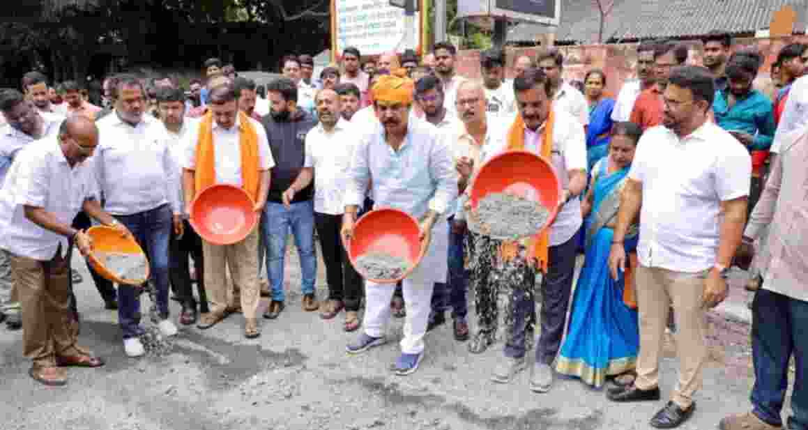 Condemning the Karnataka government's action of making people's lives miserable by not filling potholes in Bengaluru, in Banashankari, under the leadership of Leader of Opposition R Ashoka, BJP workers expressed their anger by filling the potholes on the roads on Wednesday. Condemning the Karnataka government's action of making people's lives miserable by not filling potholes in Bengaluru, in Banashankari, under the leadership of Leader of Opposition R Ashoka, BJP workers expressed their anger by filling the potholes on the roads on Wednesday.