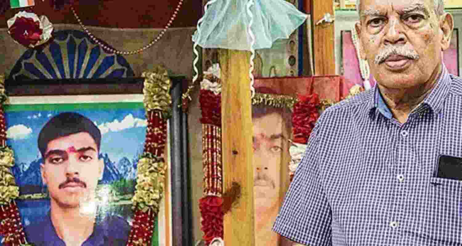 Kargil War hero Captain Saurabh Kalia's father NK Kalia stands next to a garlanded photograph of his son. Kargil War hero Captain Saurabh Kalia's father NK Kalia stands next to a garlanded photograph of his son.