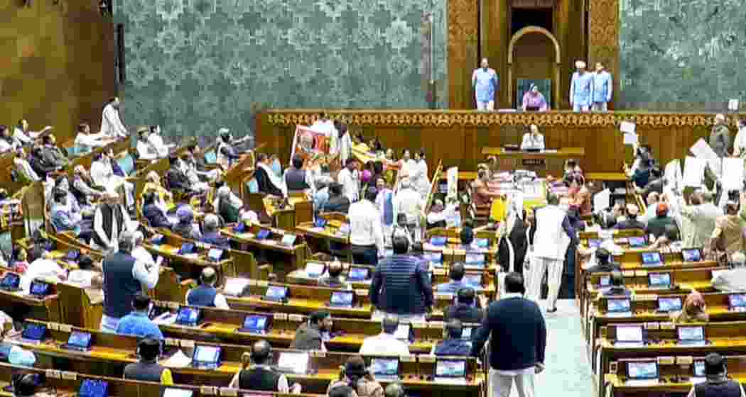 Opposition MPs protest in the Lok Sabha during the Budget session of Parliament, in New Delhi on Wednesday. Opposition MPs protest in the Lok Sabha during the Budget session of Parliament, in New Delhi on Wednesday.